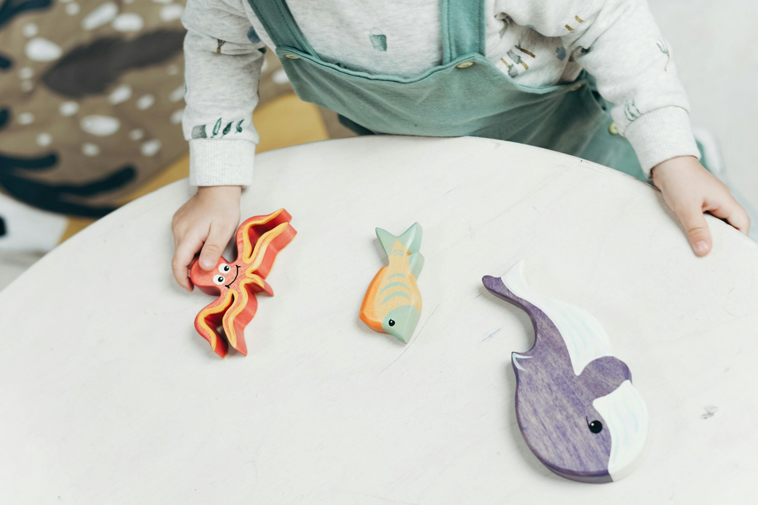 Small sea creature shaped wooden blocks on table