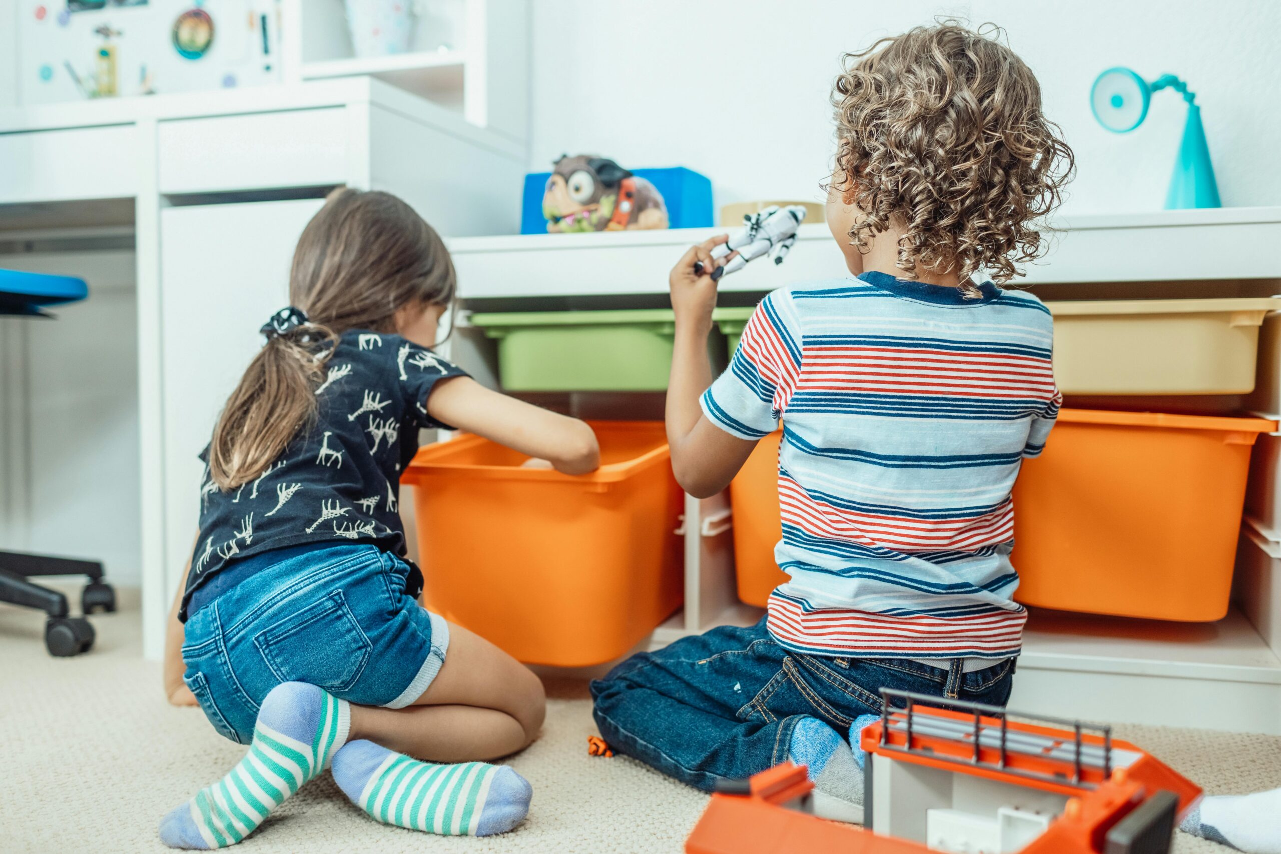 CHildren looking through toy box