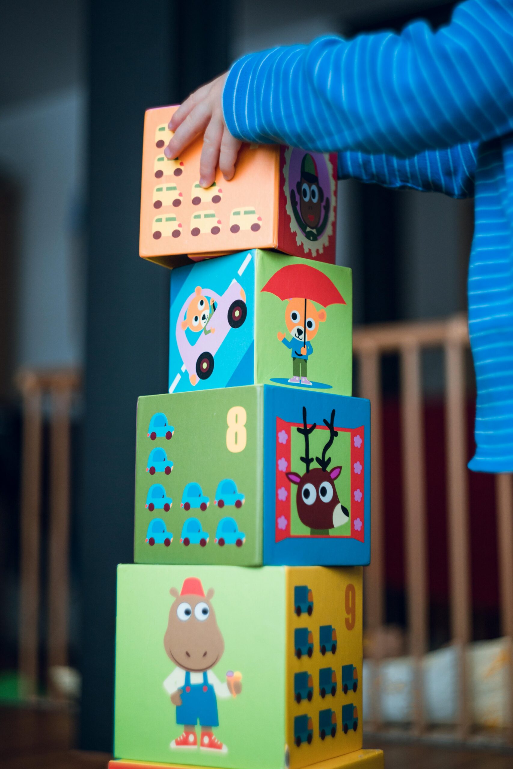 Child stacking colourful blocks