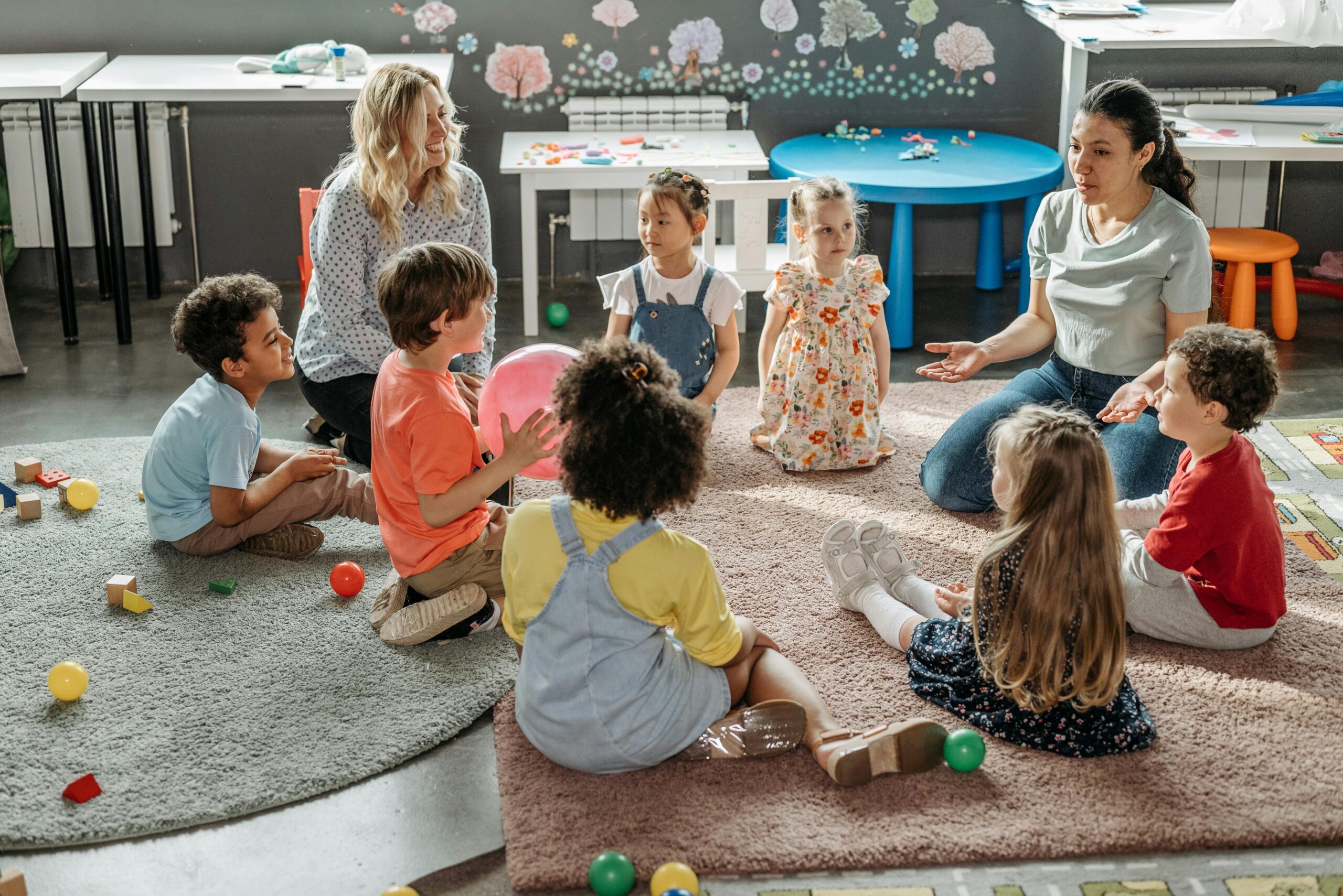 Group of children and carers sitting in circle