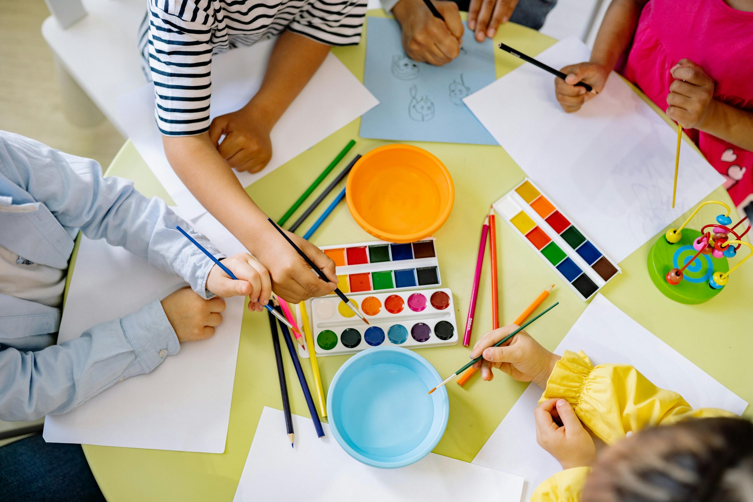 Children painting with water-colours